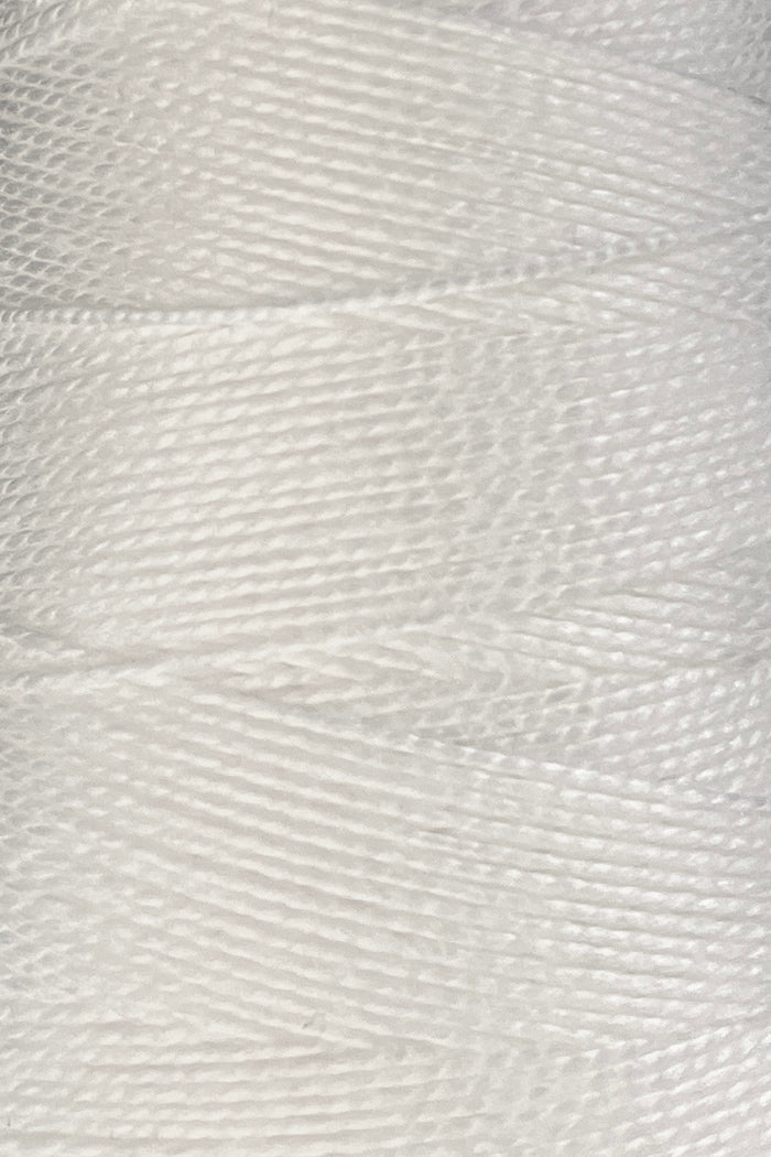 Close-up of tightly wound white 10/2 Looma Circulo Mercerized Pearl Cotton Yarn | Mini Cone by Circulo, showing the individual fibers and detailed texture.