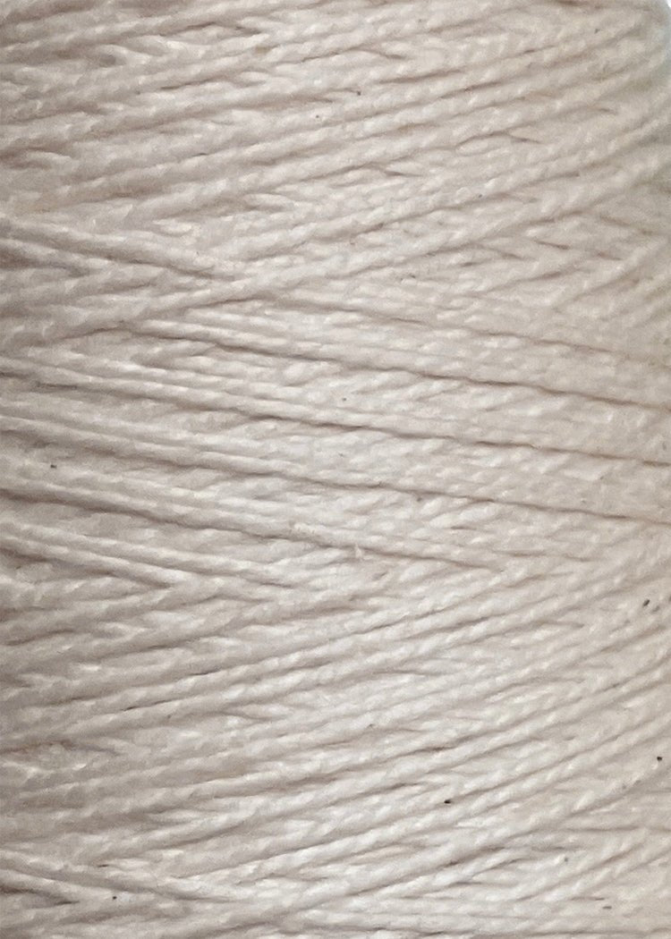 Close-up of tightly wound, off-white strands of 5/2 Looma Circulo Mercerized Pearl Cotton Yarn (Mini Cone) by Circulo, highlighting its fibrous texture; ideal Oeko-Tex certified cotton weaving yarn.