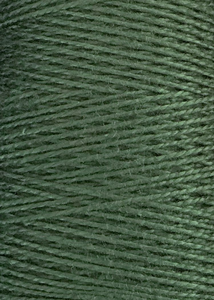 A close-up view of Circulo 5/2 Looma Mercerized Pearl Cotton Yarn (Mini Cone) showcases its green threads wound tightly in parallel rows, creating a textured and slightly shiny surface.