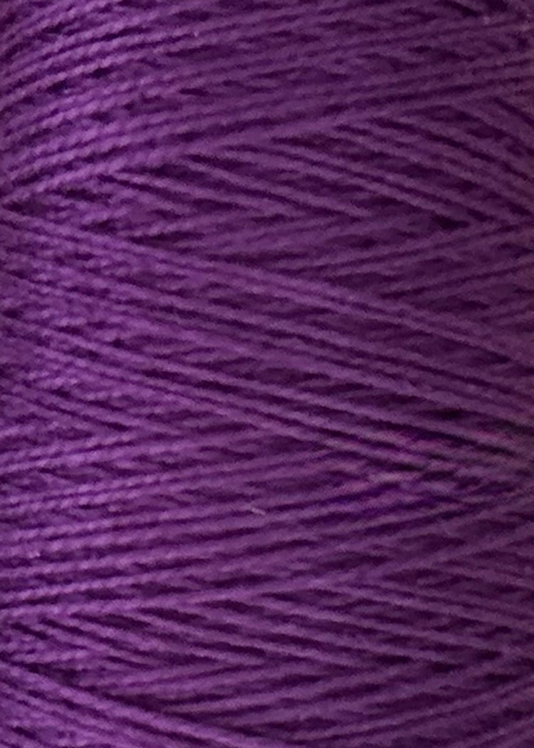Close-up of neatly wound purple thread or yarn, highlighting the texture and layered fibers—ideal for weaving projects with Circulo’s 5/2 Looma Circulo Mercerized Pearl Cotton Yarn in a large cone.