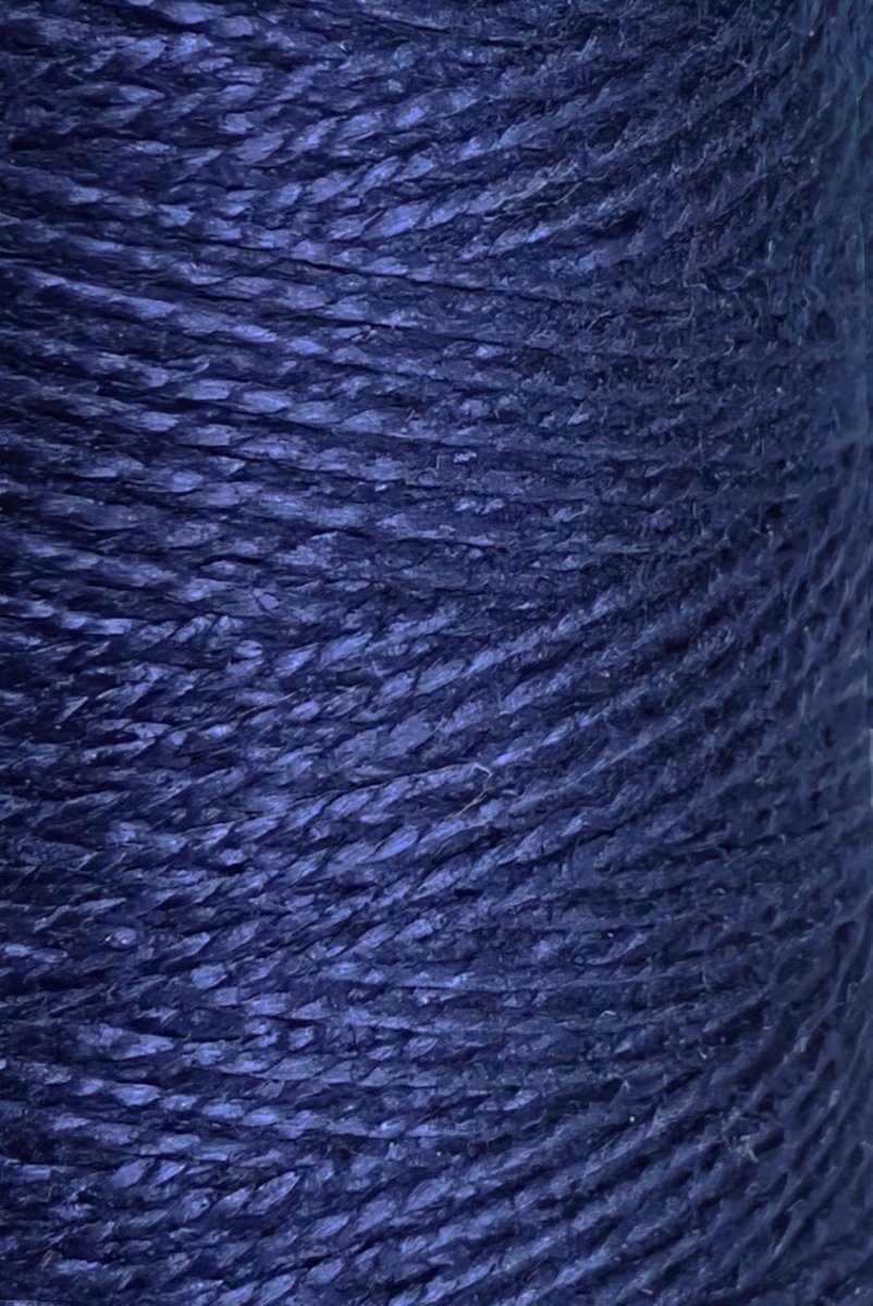 Close-up of tightly wound dark blue 5/2 Looma Circulo Mercerized Pearl Cotton Yarn | Mini Cone by Circulo, highlighting the texture and individual fibers of the strands.
