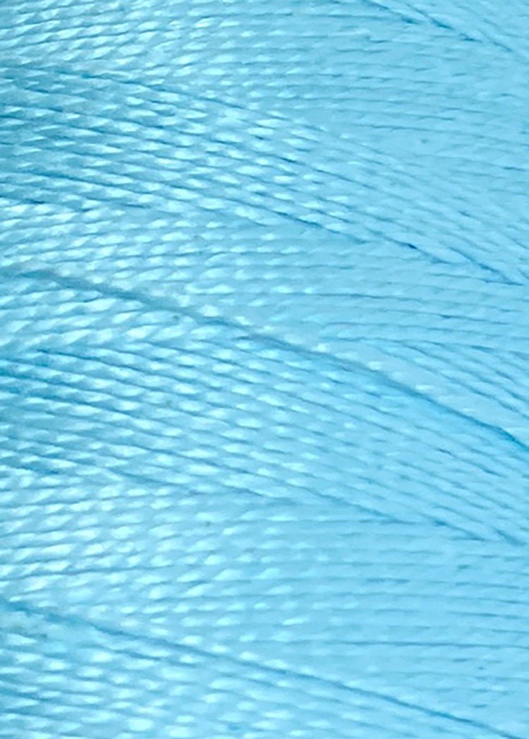 Close-up view of Circulo 5/2 Looma Mercerized Pearl Cotton Yarn in light blue, showcasing the mini cone’s smooth texture, tightly wound fibers, and subtle sheen.