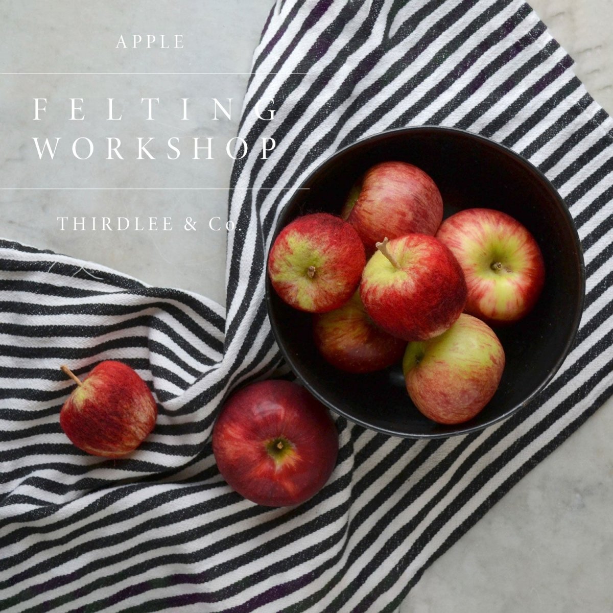 A black bowl filled with red apples, including delightful felted wool apples, sits atop a black-and-white striped cloth. Text reading “Needle Felting Class: Apples with Michelle Provençal (September 12th)” and “Halcyon Yarn” appears in white overlay.