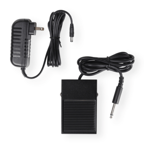 A black power adapter and footswitch pedal with ribbed surfaces and robust cables ending in a quarter-inch audio jack are shown beside an Ashford Wooden Ball Winder by Ashford Handicrafts Limited, set on a white background.