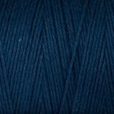 A close-up of the Cotton Carpet Warp 8/4 reveals tightly wound dark blue strands with a soft, textured surface. The fibers form a diagonal pattern, highlighting the weave and rich color—ideal for sturdy rag rugs.