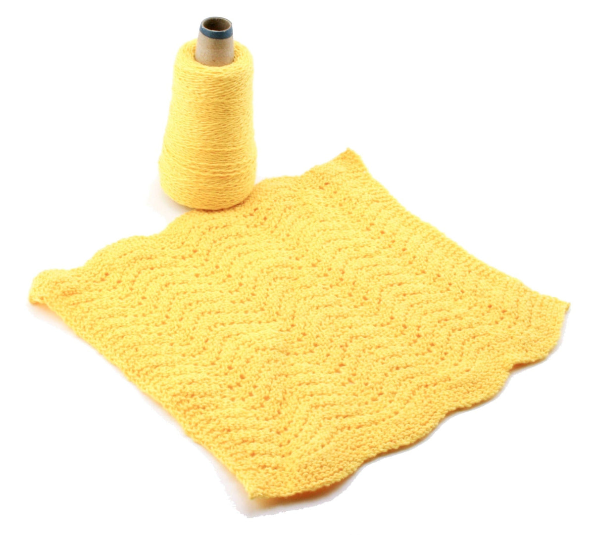 A Casco Bay Washcloths digital pattern download from Halcyon Yarn is pictured alongside a crocheted yellow square featuring a wavy, textured design—ideal for creating beautiful washcloths.