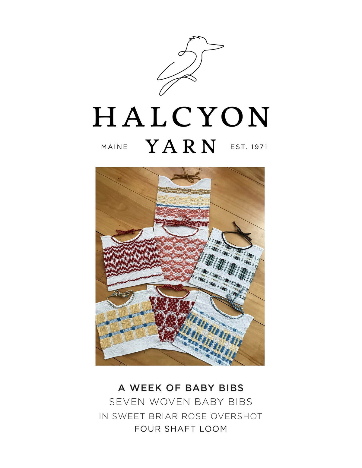 Five baby bibs made with the Show Off Baby Bib Woven Pattern by Halcyon Yarn, each featuring colorful designs, are displayed on a wooden floor. The image includes Halcyon Yarn branding and highlights this creative stash buster project.