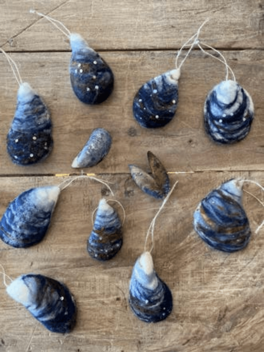 Halcyon Yarn's "Needle Felting Class: Mussel Shells with Michelle Provençal" (May 30th) features handmade blue, white, and brown mussel shell ornaments—some glittered and strung—perfect for beginner felters.
