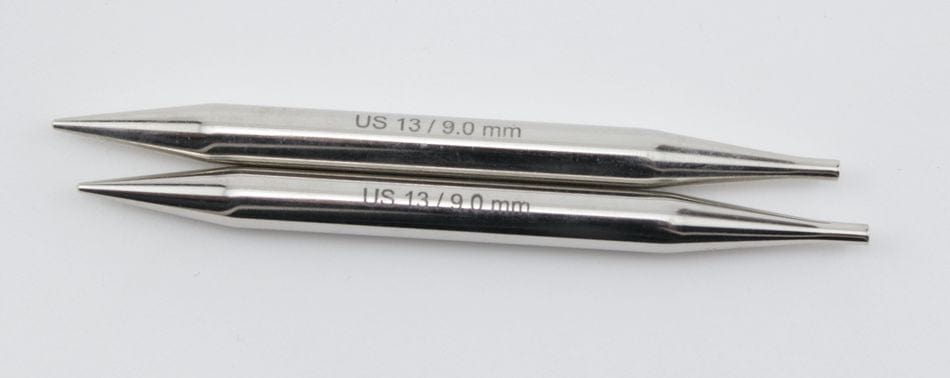 Two Accessories Unlimited Knit Pro Nova Metal Interchangeable Knitting Needles, 5", each labeled US 13 / 9.0 mm, lie parallel on a white surface, highlighting these quality knitting tools.
