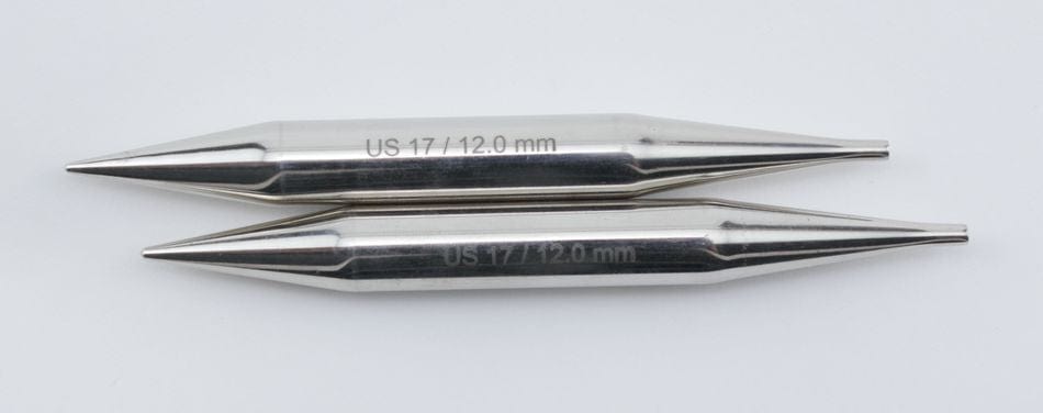 Two Knit Pro (Knitters Pride) Nova Metal Interchangeable Knitting Needles, 5" from Accessories Unlimited are laid parallel on a white surface. Both shiny silver US 17 / 12.0 mm tips feature engraved size markings.
