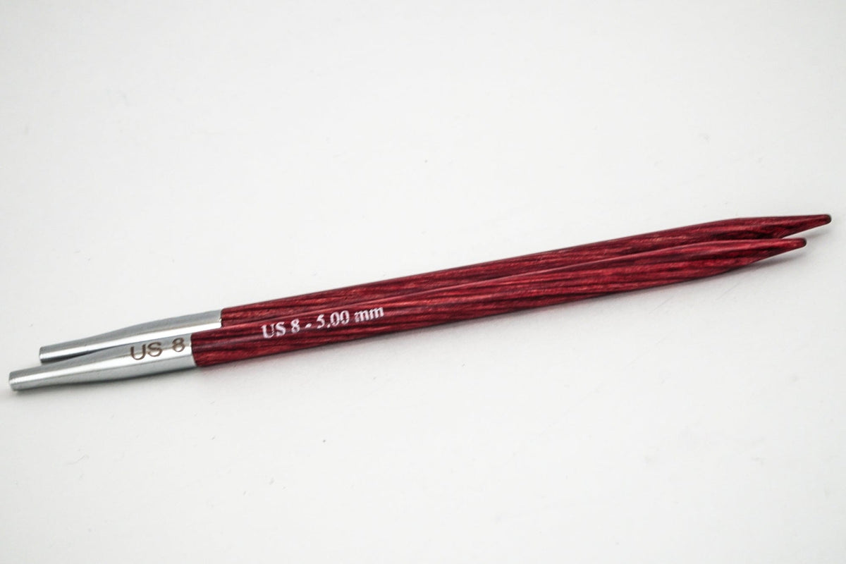 A pair of Accessories Unlimited Knit Pro (Knitters Pride) Dreamz Interchangeable Needle Tips, red laminated birch with metal ends, US 8 (5.00 mm), are displayed side by side on a white background.