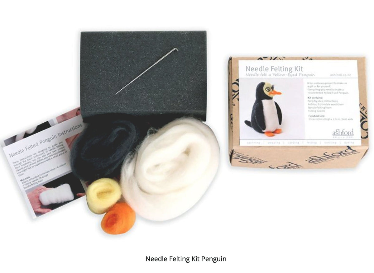 The Ashford Needle Felting Kit by Ashford Handicrafts Limited includes a needle, black, white, yellow, and orange wool, instructions, and a box with a penguin image—ideal for beginners starting their first needle felting project.