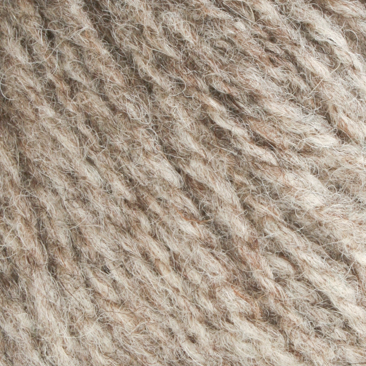 Close-up of Bartlettyarns Maine Wool Yarn (Fisherman 2-Ply) by Bartlettyarns, featuring soft, light brown and beige fibers with a textured, slightly fuzzy surface and intertwined strands.
