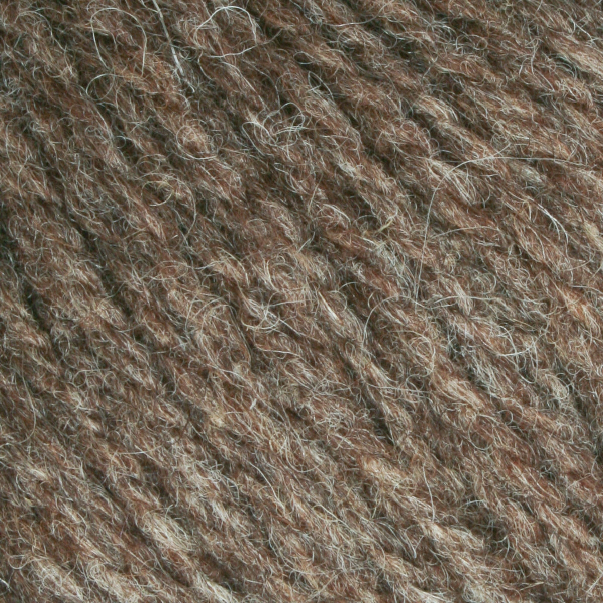 Close-up of Bartlettyarns Maine Wool Yarn (Fisherman 2-Ply) by Bartlettyarns, highlighting brown and gray twisted fibers with a textured, fuzzy surface.