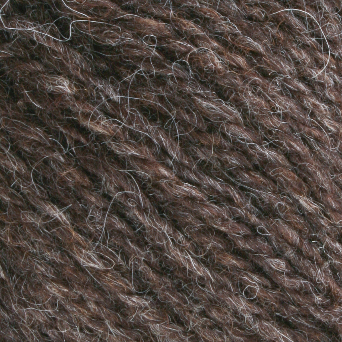 Close-up of Bartlettyarns Maine Wool Yarn (Fisherman 2-Ply) by Bartlettyarns, showcasing its textured brown and gray fibers with lighter strands interwoven throughout.
