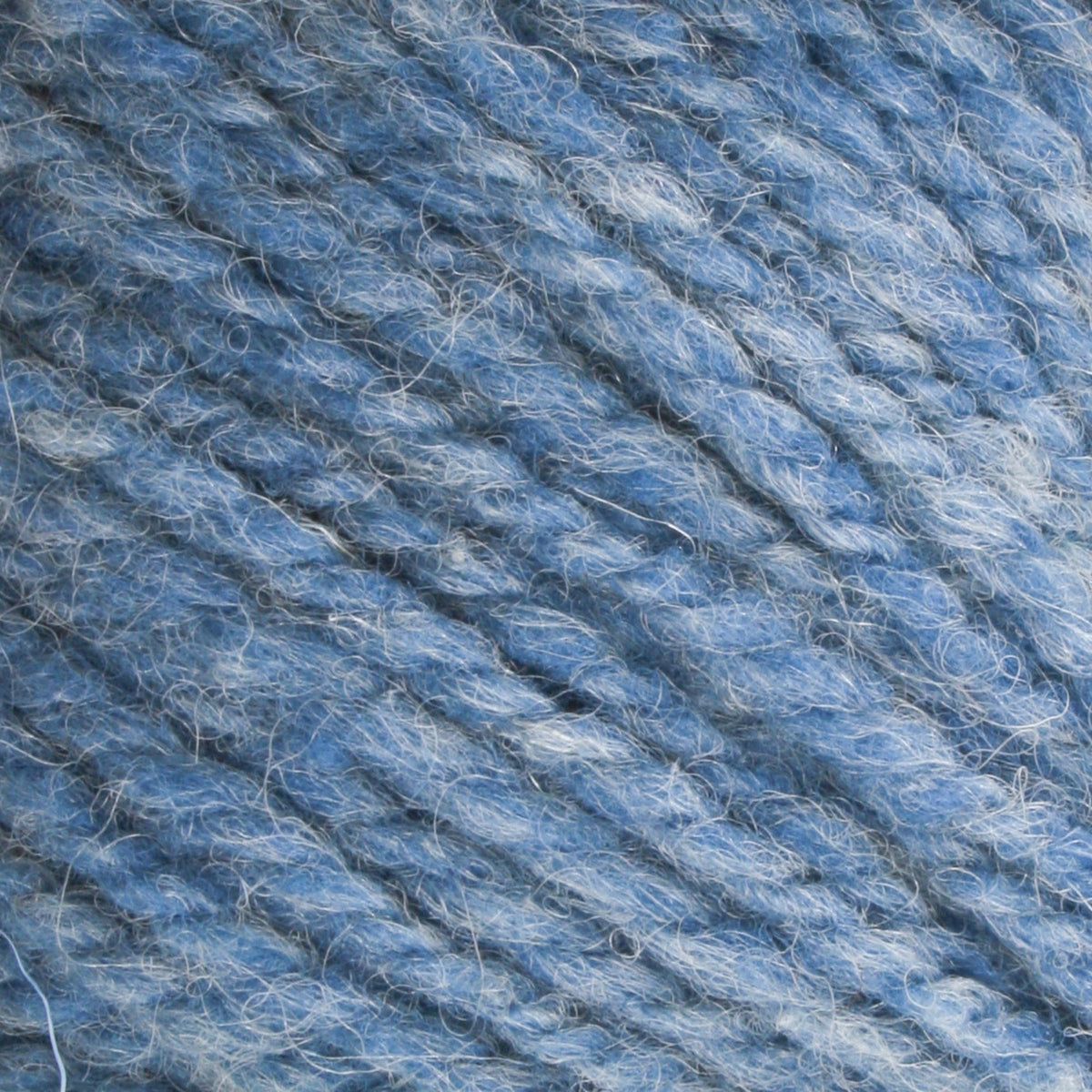 Close-up of Bartlettyarns Maine Wool Yarn (Fisherman 2-Ply) by Bartlettyarns, highlighting its thick blue worsted weight, soft fuzzy texture, and twisted fibers.