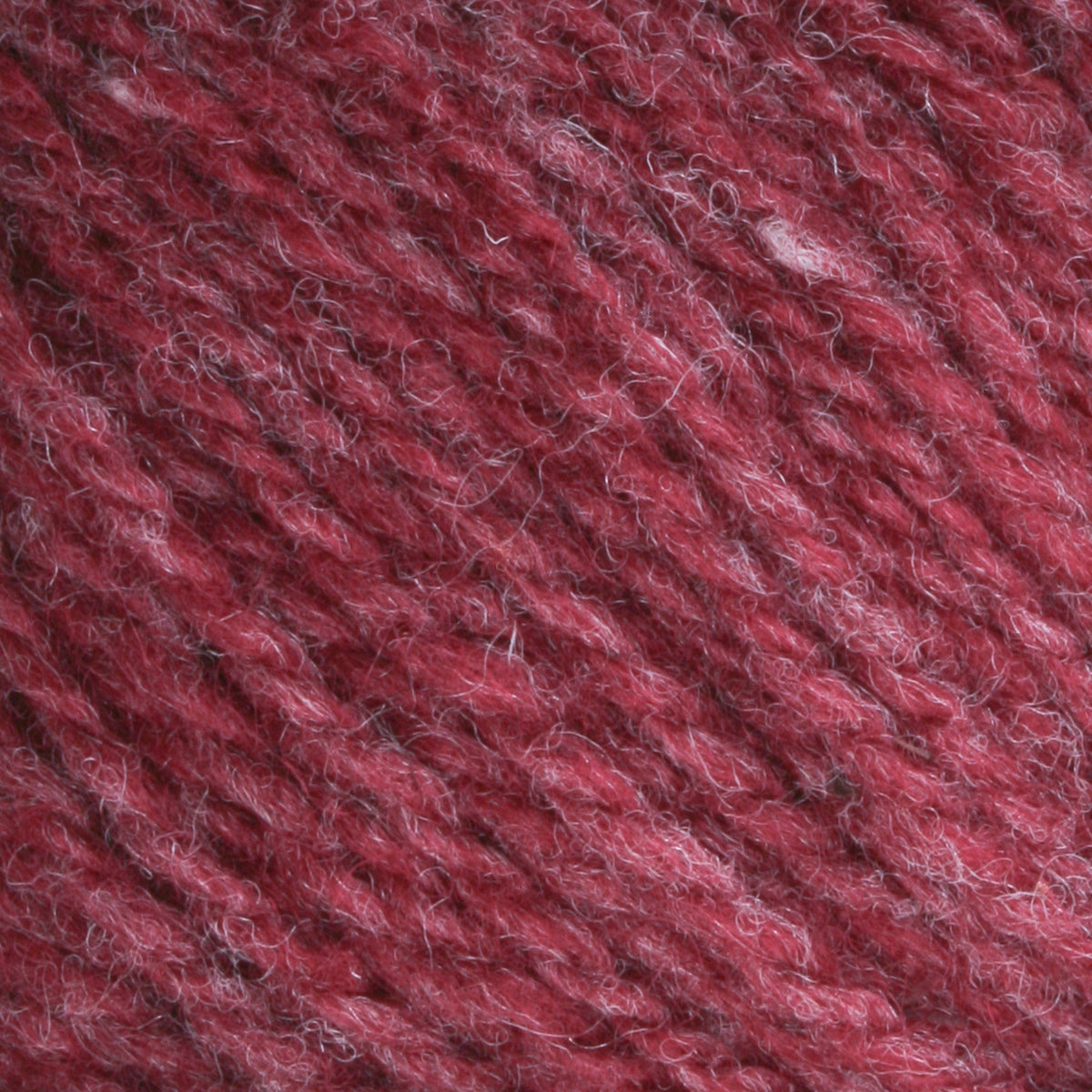 Close-up of Bartlettyarns Maine Wool Yarn (Fisherman 2-Ply) by Bartlettyarns, highlighting its textured maroon worsted weight, twisted strands, and fine fibers with subtle highlights and shadows.