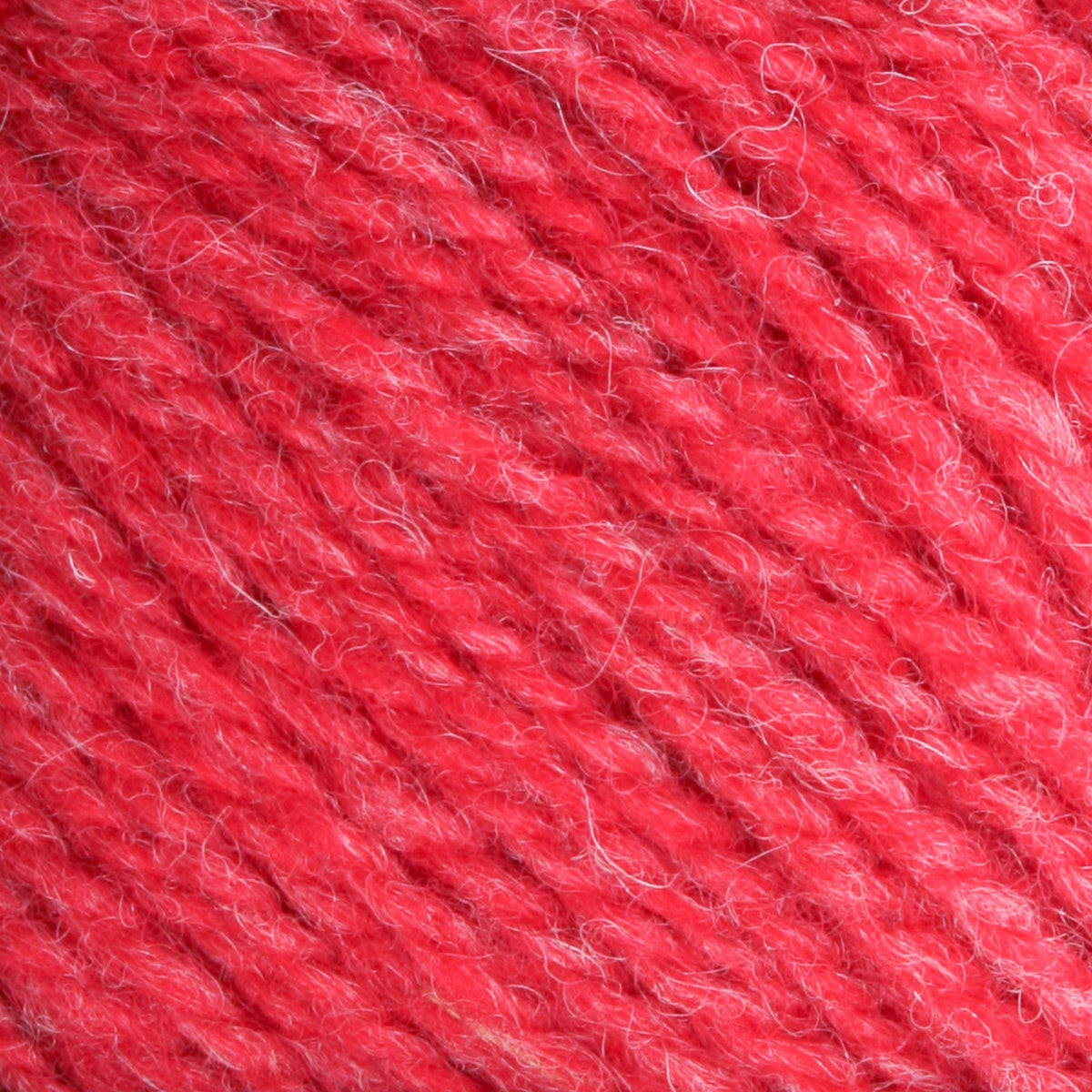 Close-up of Bartlettyarns Maine Wool Yarn (Fisherman 2-Ply) by Bartlettyarns, highlighting its textured red fibers and twisted strands for a soft, slightly fuzzy look.