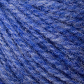Close-up of Bartlettyarns' Bartlett Maine Wool, Sport Weight Cones in blue and purple, highlighting its soft texture and twisted strands. The subtle gradient of colors creates a cozy, homespun effect.