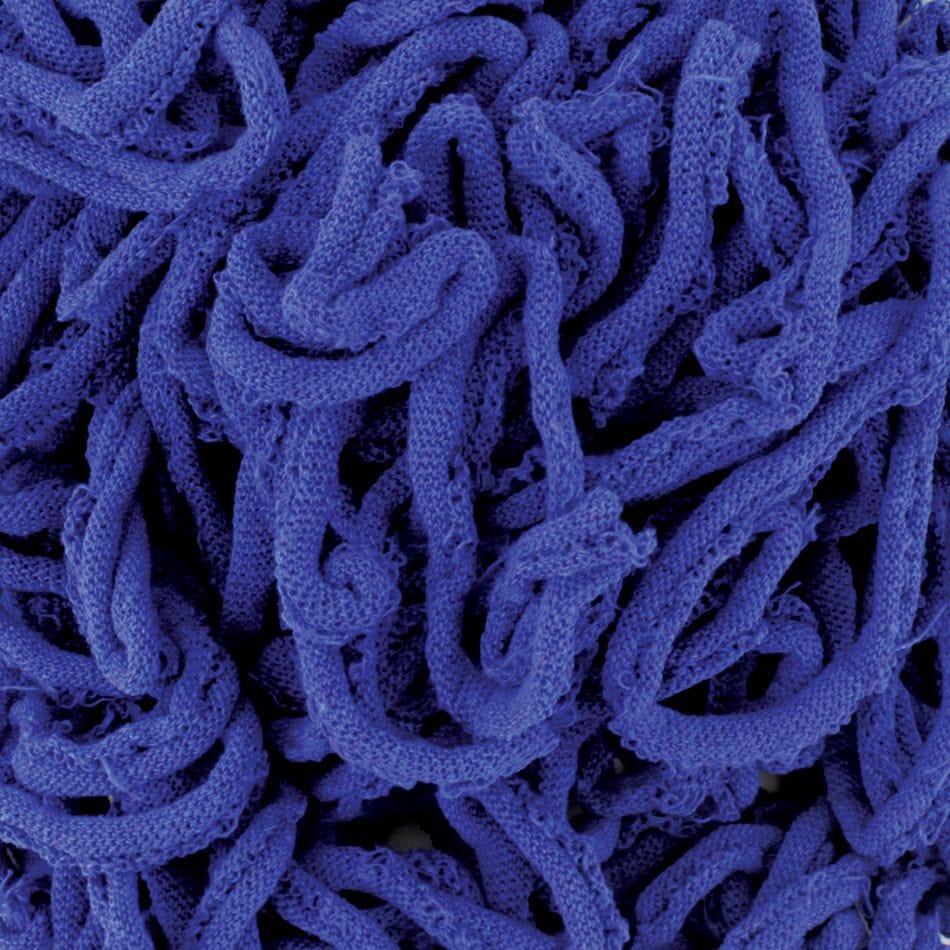 Close-up image of tangled strands from the Harrisville Potholder Loops - Traditional Size, by Friendly Loom. These blue loops intertwine in a complex pattern, resembling soft, knitted cotton crafted on a traditional loom and creating a visually intricate and dense composition.