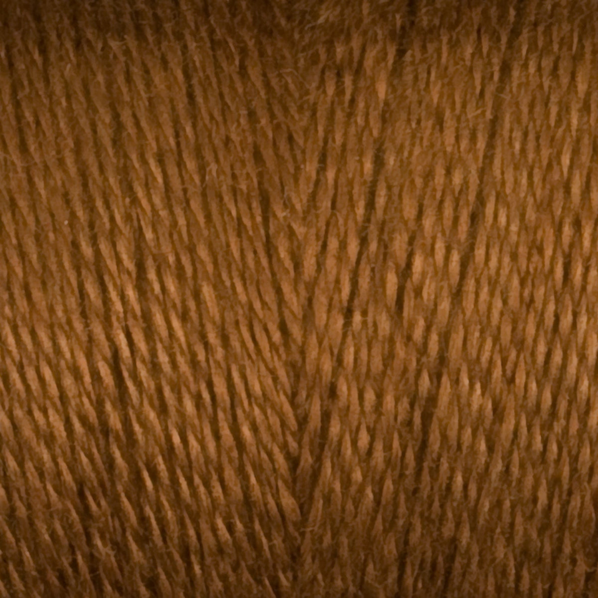Close-up of Maurice Brassard 8/2 Tencel Yarn | Mini-cone in brown, tightly wound to reveal the smooth texture and fine cellulose fibers—perfect for intricate weaving projects.