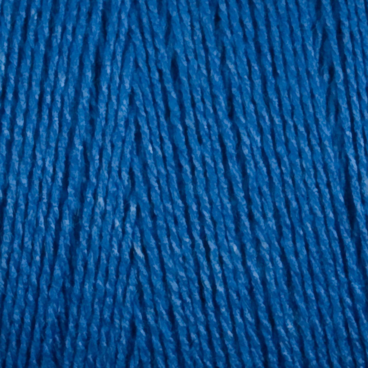 Close-up of Maurice Brassard 8/2 Tencel Yarn | Mini-cone in blue, showing its tightly packed cellulose fibers and rich texture—ideal for intricate weaving projects.