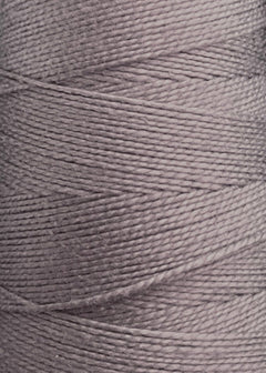 Close-up of a spool of Circulo 10/2 Looma Mercerized Pearl Cotton Yarn | Mini Cone in light gray, highlighting the texture and tightly wound strands characteristic of high-quality mercerized cotton yarn.