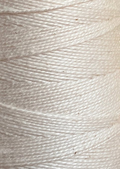 A close-up of the tightly wound 3/2 Looma Circulo Mercerized Pearl Cotton Yarn on a large cone highlights the intricate texture and pattern of the fibers. This 100% cotton weaving yarn from Circulo is Oeko-Tex certified for quality and safety.