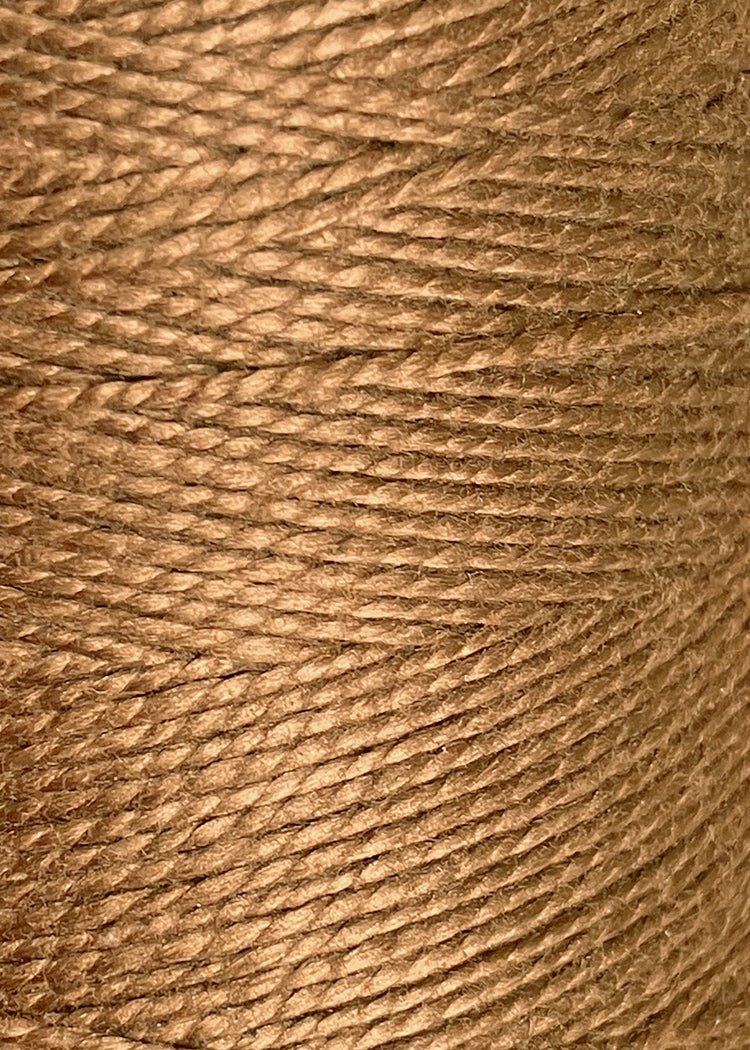 Close-up of tightly wound brown twine or rope showcases its texture and fibers—crafted from Circulo 5/2 Looma Mercerized Pearl Cotton Yarn | Mini Cone for added strength and smoothness.