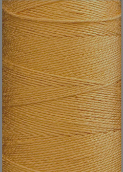 Close-up of a spool of Circulo 5/2 Looma Mercerized Pearl Cotton Yarn | Mini Cone in golden yellow, tightly wound in neat, diagonal layers with a smooth, shiny texture.
