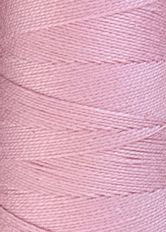 Close-up of a spool of Circulo 5/2 Looma Mercerized Pearl Cotton Yarn | Mini Cone in light pink, highlighting the fine texture and diagonal pattern of the wound thread fibers.
