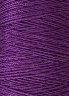 Close-up of tightly wound purple thread on a spool, showing the texture and pattern of the strands. This is Circulo’s 10/2 Looma Mercerized Pearl Cotton Yarn in a large cone, an Oeko-Tex certified weaving yarn that highlights its quality and vibrant color.