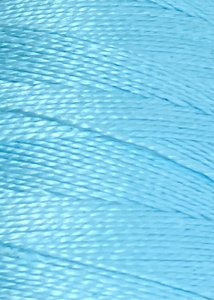 Here’s your rewritten sentence using the provided product data: Close-up of shiny, light blue Circulo 10/2 Looma Circulo Mercerized Pearl Cotton Yarn | Mini Cone labeled 030-2151 Sky at the bottom. The weaving yarn appears smooth and glossy, with a soft texture reminiscent of high-quality pearl cottons.