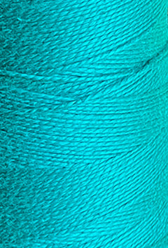 Close-up of a spool of Circulo 5/2 Looma Mercerized Pearl Cotton Yarn | Mini Cone in bright turquoise, highlighting the detailed texture and tightly wound 100% cotton fibers. This pearl cotton thread is Oeko-Tex certified, ensuring both quality and safety.
