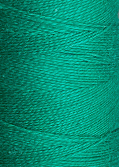 Close-up of green thread wound tightly around a spool, highlighting the detailed texture and fine fibers of the 3/2 Looma Circulo Mercerized Pearl Cotton Yarn | Large Cone by Circulo, which is Oeko-Tex certified for safety and quality.
