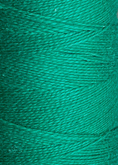 Close-up of a spool of vivid green 10/2 Looma Circulo Mercerized Pearl Cotton Yarn | Mini Cone by Circulo, highlighting the texture of its tightly wound strands. This Oeko-Tex certified pearl cotton offers vibrant color and reliable quality for your crafting projects.
