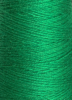 A close-up of a spool of Circulo 3/2 Looma Mercerized Pearl Cotton Yarn in green reveals the finely textured, tightly wound fibers—made from 100% cotton, this large cone of weaving yarn from Circulo offers both exceptional strength and softness.