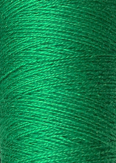 Close-up of vibrant green Circulo 10/2 Looma Mercerized Pearl Cotton Yarn, tightly wound on a mini cone, highlighting its smooth texture and visible individual fibers.