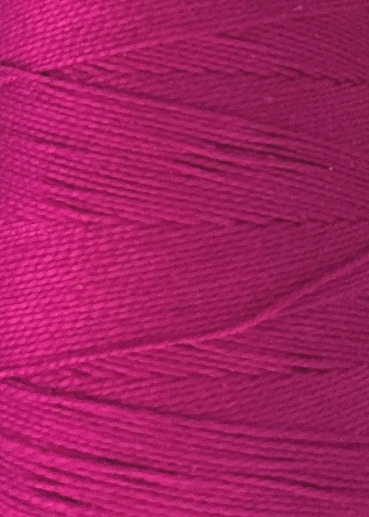 Close-up of magenta-colored 5/2 Looma Circulo Mercerized Pearl Cotton Yarn | Mini Cone by Circulo, tightly wound around a spool to highlight the thread's texture and fine fibers.