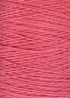 Close-up of thick pink Circulo 5/2 Looma Mercerized Pearl Cotton Yarn, wound in overlapping layers to create a textured pattern. This Oeko-Tex certified yarn, available on a mini cone, ensures both quality and safety.