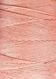 Close-up of a spool of light pink 5/2 Looma Circulo Mercerized Pearl Cotton Yarn | Large Cone by Circulo, highlighting the smooth texture and the tightly wound diagonal layers of thread around the cone.