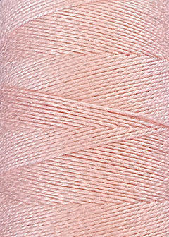 Close-up of a spool of pale pink thread, tightly wound in overlapping diagonal layers, showcasing the smooth and glossy texture of the individual strands—crafted from premium 5/2 Looma Circulo Mercerized Pearl Cotton Yarn | Mini Cone by Circulo.