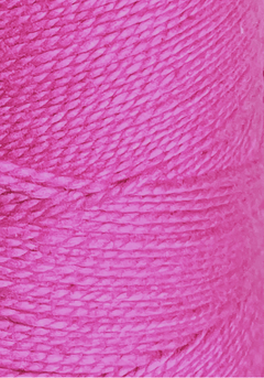 Close-up of vibrant pink 3/2 Looma Circulo Mercerized Pearl Cotton Yarn by Circulo, wound tightly in thick layers on a large cone to showcase the texture and fine fibers of the thread.