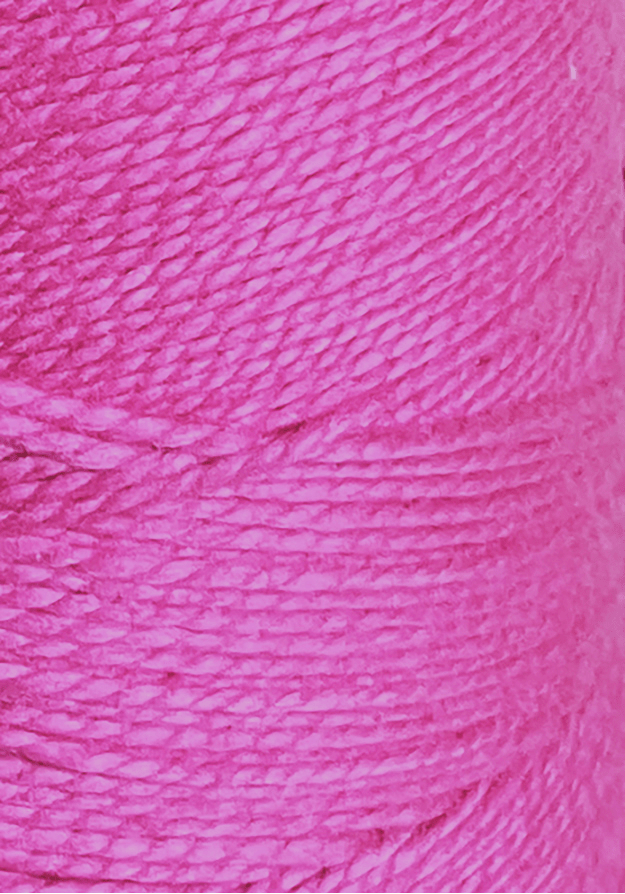 Close-up of a spool of Circulo 5/2 Looma Circulo Mercerized Pearl Cotton Yarn | Mini Cone in bright pink, highlighting the texture and tightly wound fibers of this premium weaving yarn.