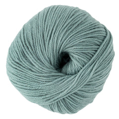 A tightly wound ball of Cascade Yarns' Cascade 220 Superwash Wool Yarn in light teal DK weight, with visible strands and a hollow center. The soft, smooth yarn is photographed against a white background.