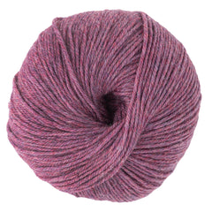A close-up of a ball of Cascade 220 Superwash Wool Yarn by Cascade Yarns, DK weight, in a heathered pinkish-purple shade, tightly wound and neatly round.