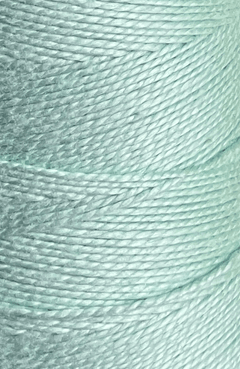 Close-up of a spool of Circulo 3/2 Looma Mercerized Pearl Cotton Yarn in light blue, highlighting the detailed texture and diagonal winding pattern of the fibers on this large cone.