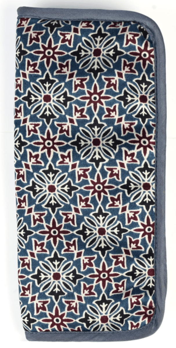 The Lantern Moon Interchangeable Needle Case by Bryson Distributing, Inc. is a handcrafted rectangular IKAT fabric pouch with a blue, white, and maroon geometric floral pattern and dark blue trim—ideal for storing interchangeable needles.
