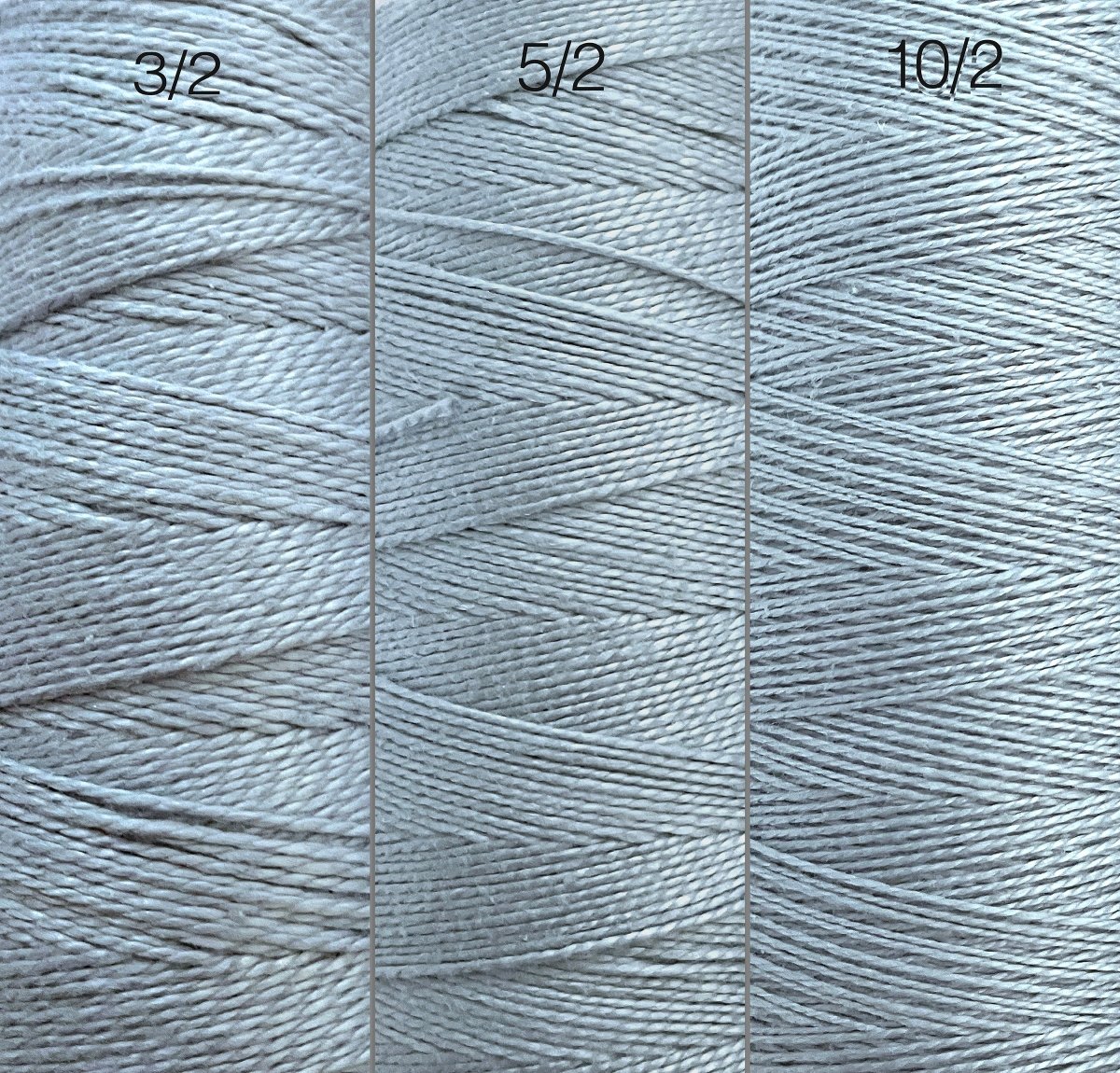 Close-up of three large cones of Circulo Looma Mercerized Pearl Cotton Yarn in light gray, labeled 3/2, 5/2, and 10/2, highlighting the variations in thickness and texture among the different types.