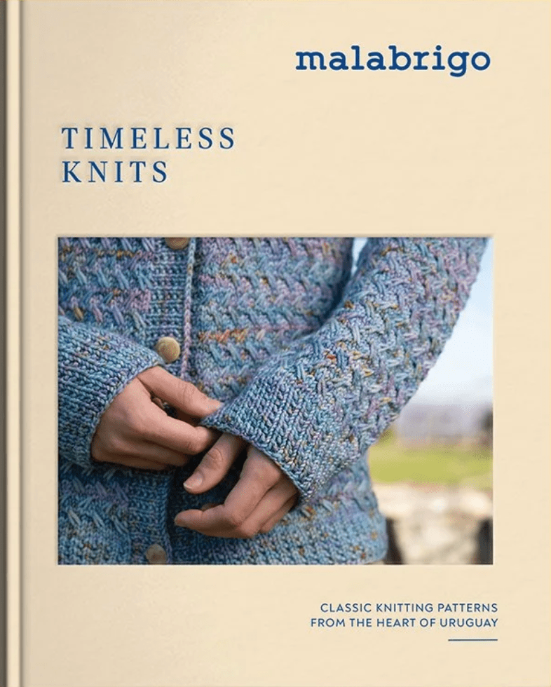 The cover of Timeless Knits, Malabrigo by Malabrigo Yarn shows a close-up of someone buttoning a colorful textured cardigan knit from hand-dyed yarn. Subtitle: Classic Knitting Patterns from the Heart of Uruguay.